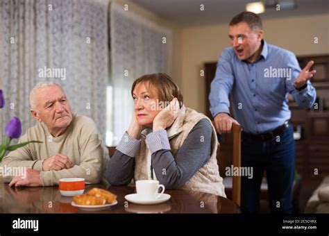 Adult Annoyed Man Scolding His Senior Parents At Home Stock Photo Alamy