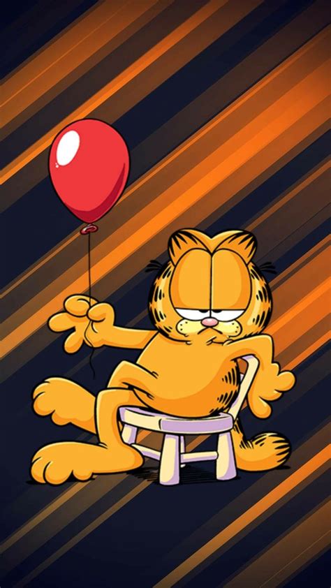 Garfield The Cat Sitting On A Stool With A Red Balloon In His Hand And