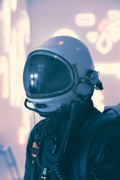 A Man In A Space Suit With A Helmet And Goggles On His Face Is Looking Into The Distance
