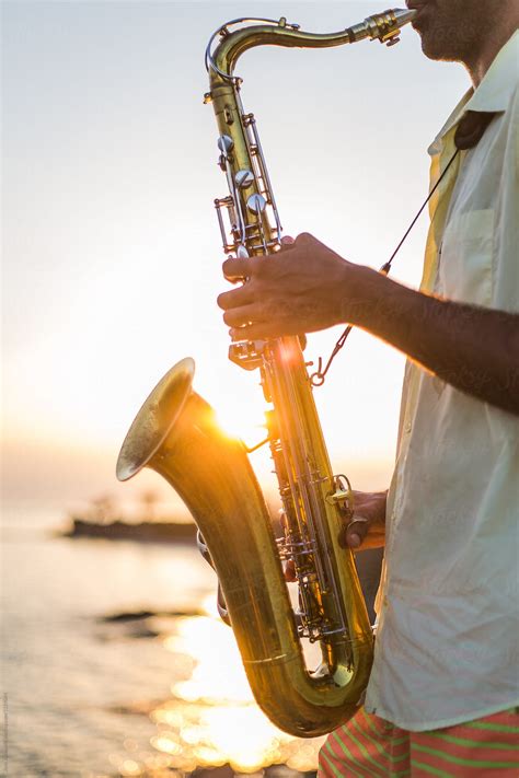 Man Playing Saxophone At The Beach By Stocksy Contributor Jovo