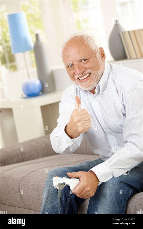 Older Man Giving Thumb Up With Computer Game Stock Photo Alamy
