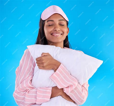 premium photo sleep happy and a woman hugging a pillow isolated on a blue background in a