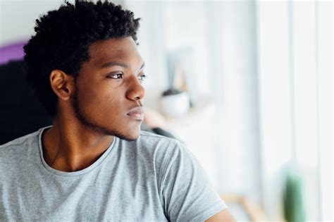 Melancholic Headshot Portrait Of Young Black Man Looking Aside Isolated