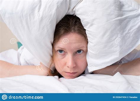 Insomnia Bad Sleep Migraine Headache A Woman In Bed Covered Herself With A Pillow Cannot