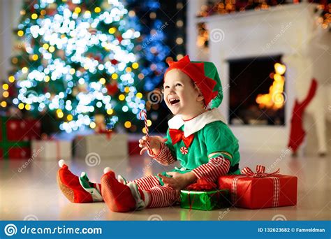 Gifted children are often more advanced in academics or creative fields. Kids At Christmas Tree. Children Open Presents Stock Photo ...