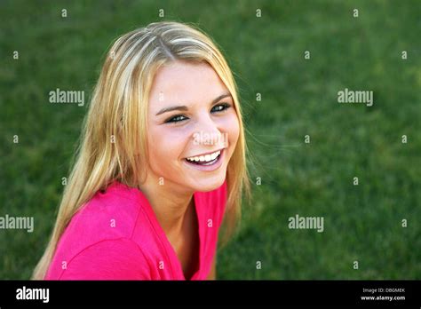Beautiful Blonde Teen Girl Smiling In Grass Stock Photo Alamy