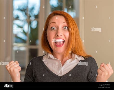 Redhead Woman At Home Screaming Proud And Celebrating Victory And Success Very Excited Cheering