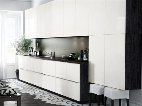 Spacious storage in several beautiful finishes. Modern IKEA kitchen with black brown cabinets, high gloss ...