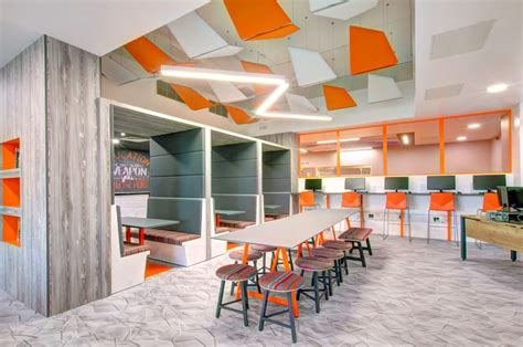 A Modern Breakout Area With Benching And Funky Striped Chairs And