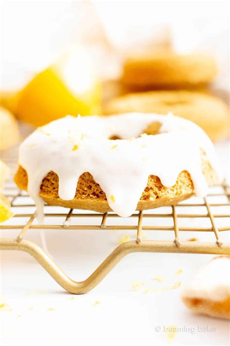 A Close Up Of A Doughnut On A Rack With Lemons In The Background