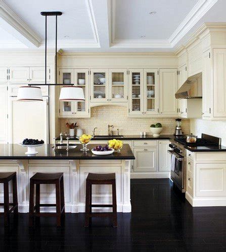 An all white kitchen cabinet paired with black granite countertops provides a more subtle contrast perfect for small spaces. black-tile-floors-kitchen3
