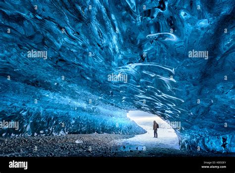 View From Inside Ice Cave Under The Vatnajokull Glacier With Person For