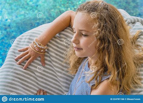 Beautiful Young Girl Relaxing On A Chair Near Swimming Pool Young Model Lying On Sun Lounger