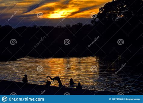 Children Dive In The Lake At Dusk Stock Photo Image Of Environment