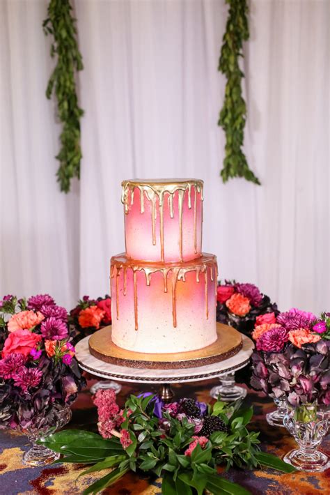 Two Tier Round Pink And White Ombre Wedding Cake With Gold Drip Frosting On Gold Cake Stand With