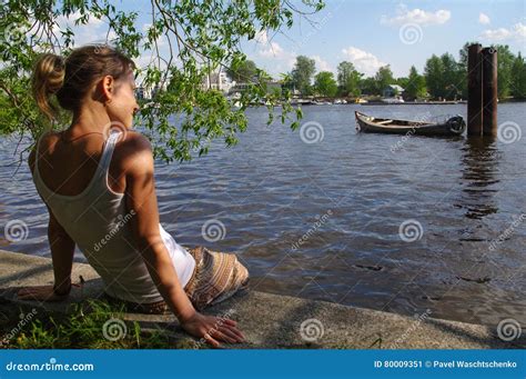 Girl Sitting On Pier And Looking At The River Woman Relaxing By A Lake Stock Image Image Of