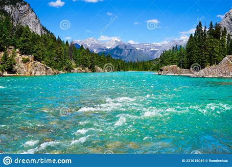 Bow River In Banff National Park With Canadian Rockies In Background