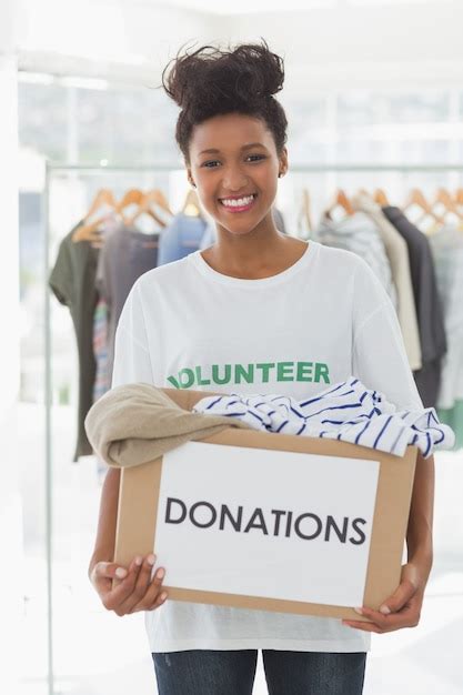 Premium Photo Smiling Young Woman With Clothes Donation