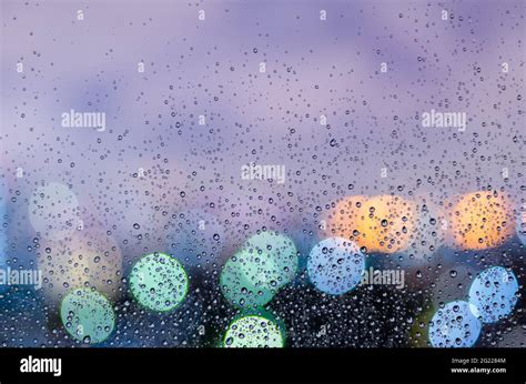Rain Drop On Glass Window In Monsoon Season With Colorful Bokeh Light