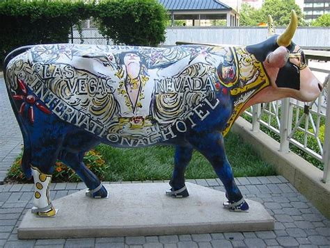 a statue of a cow is on display outside