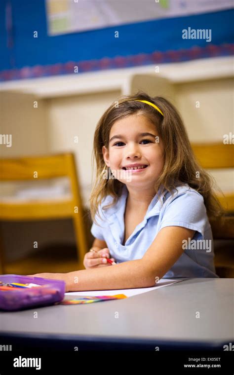 Girl Smiling In Classroom Stock Photo Alamy