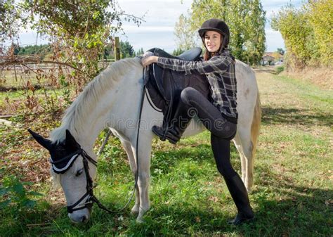 Young Woman Rider Mounting A White Horse Stock Photo Image Of