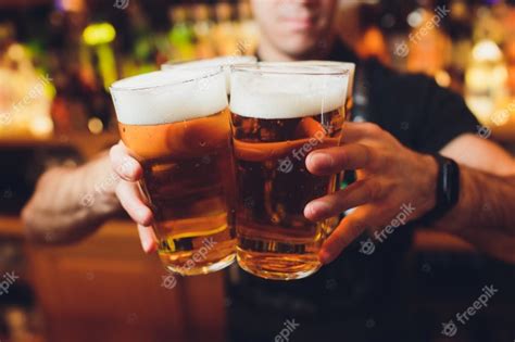 Premium Photo Barman Hands Pouring A Lager Beer In A Glass