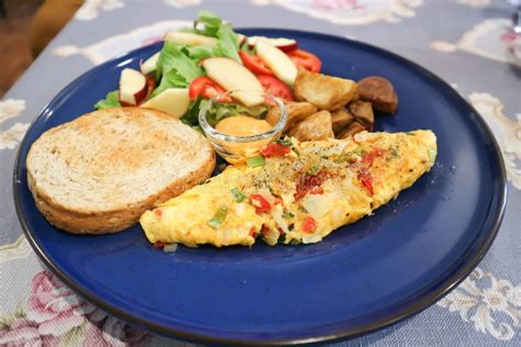 Omelette Omelet Or Scrambled Egg With Salad And Fried Potato And
