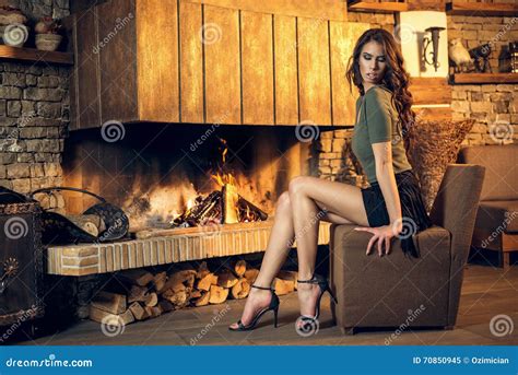pretty brunette posing near burning fireplace stock image image of cosy hair 70850945