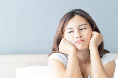 Closeup Woman Sitting On Bed In The Bedroom With Depressed Feeling