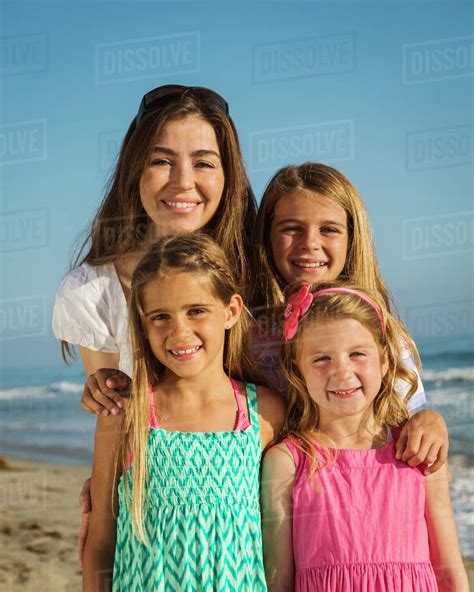 Caucasian Mother And Daughters Smiling On Beach Stock Photo Dissolve