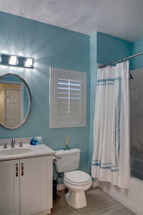 We adore it for kitchens, but we are fans of it in bathrooms, too. I love the color of the teal wall paint in this bathroom