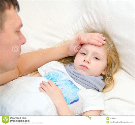 Father Checks Temperature Of Sick Daugher With His Hand Stock Image