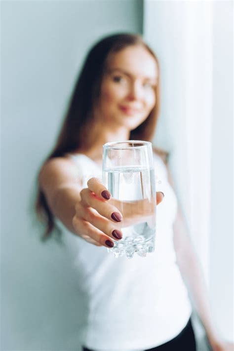 Closeup Young Woman Show Glass Of Water Portrait Of Happy Smiling