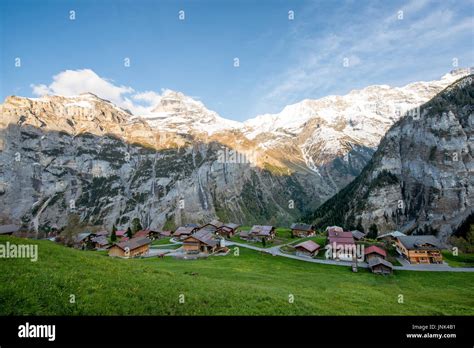 Farmhouse In Village With Swiss Alps Snow Mountain In Background In