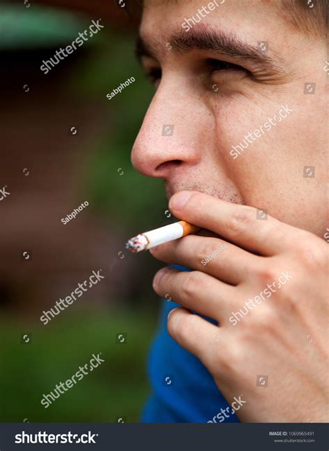 Sad Young Man Smoking Cigarette Closeup Stock Photo 1069965491