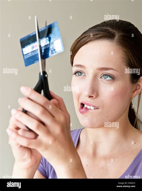 Woman Cutting Up Credit Card Stock Photo Alamy