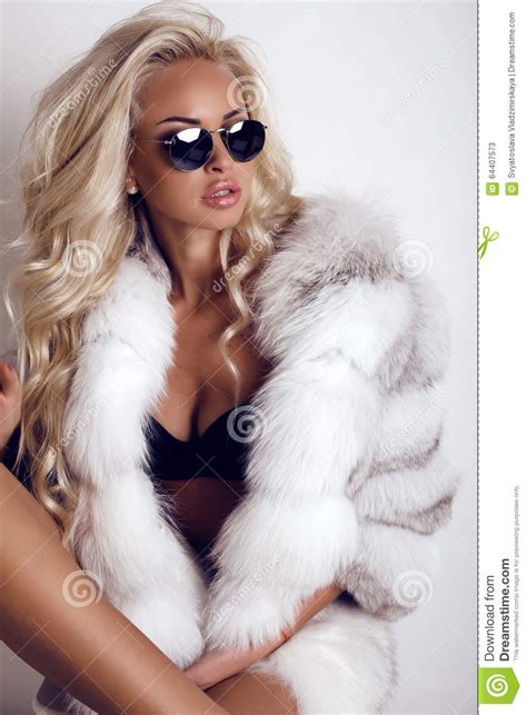 Sexy Woman With Long Blond Hair Wears Luxurios Fur Coat And Sunglasses