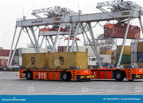 Automated Vehicles Moving Shipping Containers To And From Gantry Cranes