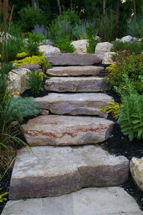 One of the real advantages of using natural stone boulders in your landscape is that they offer the wondrous effect of revealing nature's pure beauty. stone steps | Landscaping with rocks, Garden stairs, Garden steps