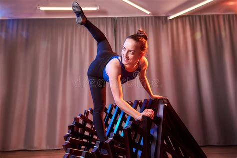Flexible Beautiful Gymnast Girl Doing Gymnastic Exercises With Chair In The Hall Or On The Stage