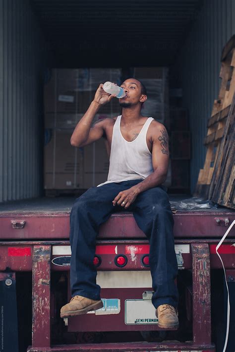 A Babe Man Sitting And Drinking A Bottle Of Water By Stocksy Contributor Anya Brewley