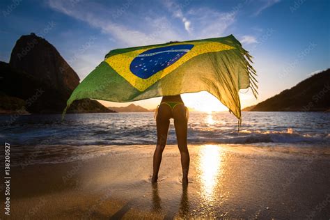 Sexy Girl In Bikini Holding Beach Yoke With Brazilian Flag Waving In