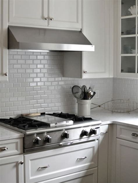 By bringing the backsplash from the countertops to the ceiling, the designer created a sizable accent wall that appears as if it was carved right out of the earth. Kitchen Subway Tiles Are Back In Style - 50 Inspiring Designs