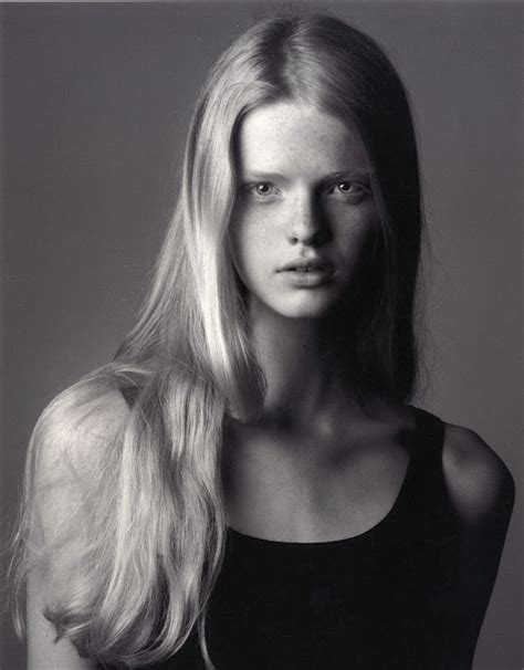 A Woman With Long Blonde Hair Posing For A Black And White Photo