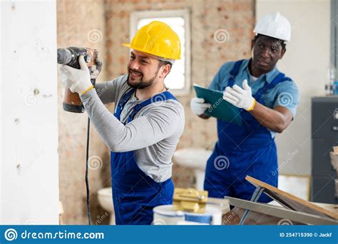 Confident Builder Posing On Indoor Construction Site Stock Photo