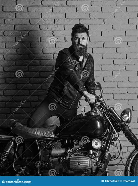 Hipster Brutal Biker On Serious Face In Leather Jacket Gets On
