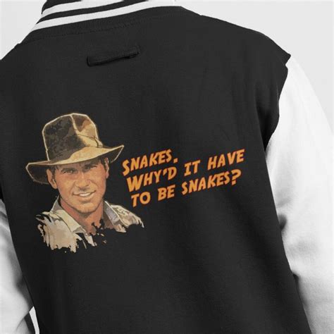 In the film indiana jones and the last crusade, a young indy is on an adventure in which he falls into a circus train full of snakes. (X-Small (3-4 yrs), Black/White) Indiana Jones Snakes Quote Kid's Varsity Jacket on OnBuy