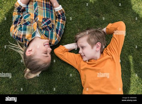 Top View Of Little Boy And Girl Looking At Each Other While Lying On