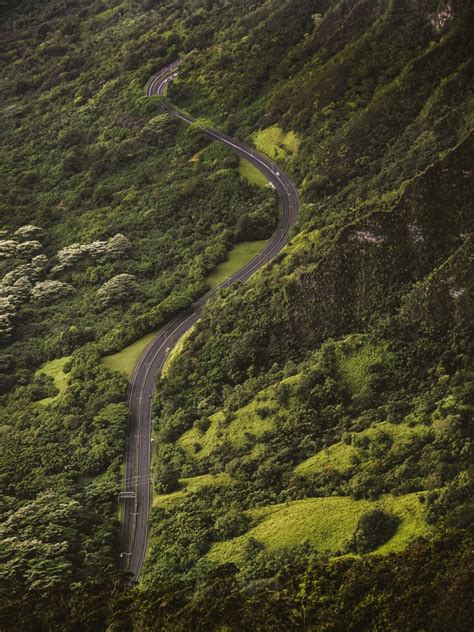 A Winding Road Among Green Wooded Hills In Hawaii Winding Around 4k